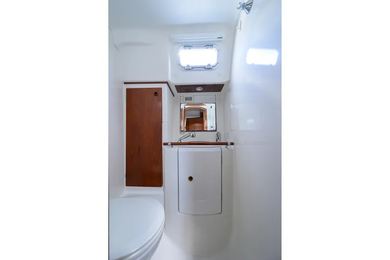 Windigo Yacht Photos Pics Bathroom interior of 2003 Beneteau 50 yacht, featuring compact design and wooden accents.
