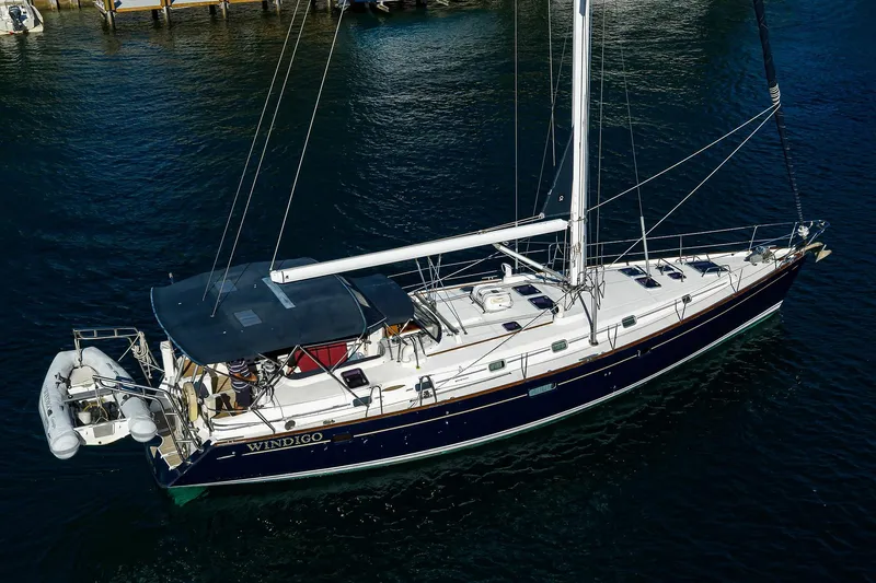 Windigo Yacht Photos Pics 2003 Beneteau 50 sailboat on water, aerial view, with dinghy attached.