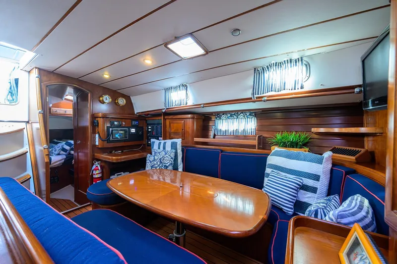 Windigo Yacht Photos Pics Luxurious interior of 2003 Beneteau 50 yacht with cozy seating and elegant wood finish.