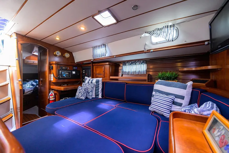 Windigo Yacht Photos Pics Luxurious interior of 2003 Beneteau 50 yacht with blue seating and nautical decor.