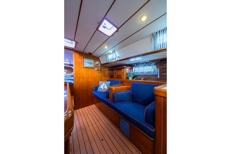 Windigo Yacht Photos Pics Luxurious interior of 2003 Beneteau 50 yacht with blue seating and wood finish.