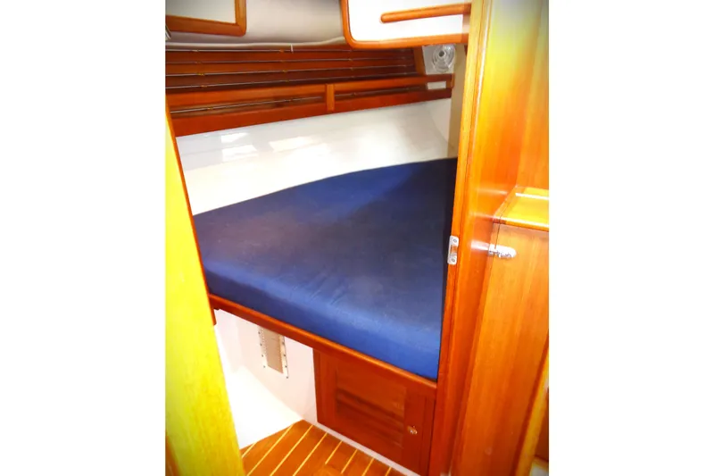 Indigo Yacht Photos Pics Cozy cabin interior of 2005 Pacific Seacraft 40 sailboat with blue bedding.