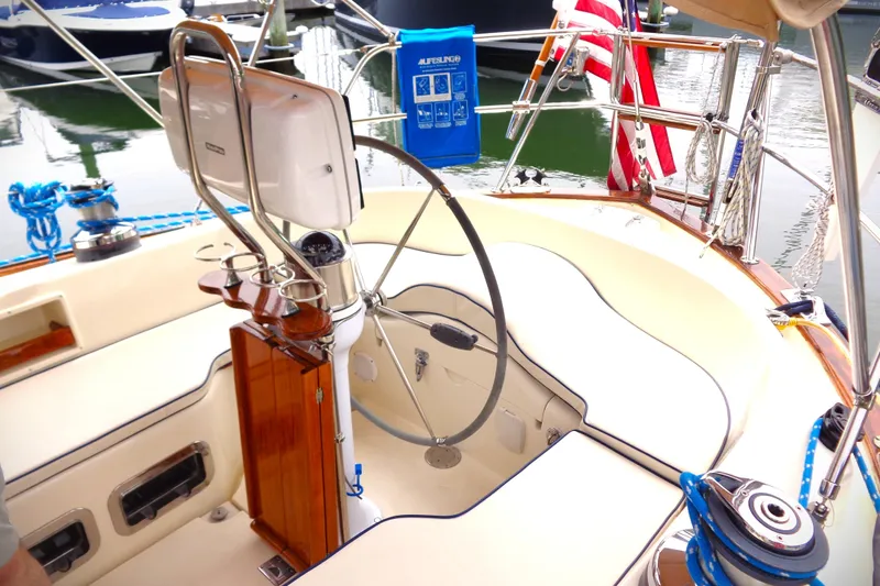 Indigo Yacht Photos Pics Cockpit of 2005 Pacific Seacraft 40 sailboat with steering wheel and navigation equipment.