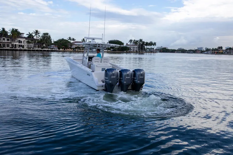 Bandit Yacht Photos Pics 2018 Jupiter 38 FS boat cruising on calm water with triple outboard engines.