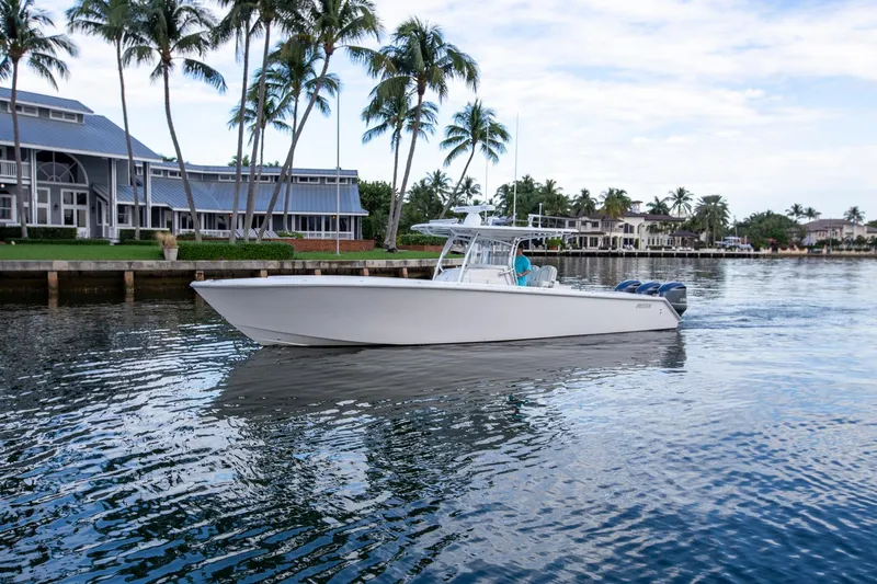 Bandit Yacht Photos Pics 2018 Jupiter 38 FS boat cruising on a scenic waterfront with palm trees.