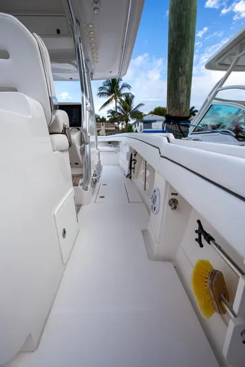 Bandit Yacht Photos Pics 2018 Jupiter 38 FS boat deck with seating, palm trees, and blue sky background.