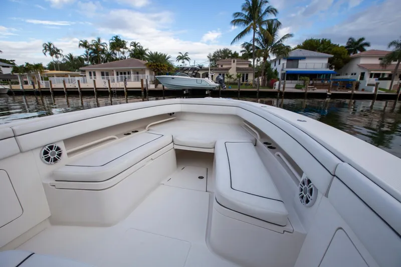 Bandit Yacht Photos Pics 2018 Jupiter 38 FS boat interior with white seating, docked near waterfront homes.