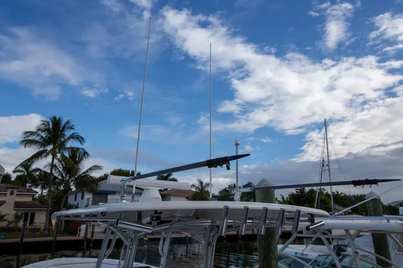 Bandit Yacht Photos Pics 2018 Jupiter 38 FS boat with antennas, docked under a partly cloudy sky.
