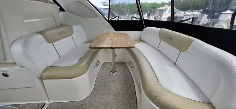  Yacht Photos Pics Interior of 2009 Sea Ray 310 Sundancer with beige seating and wooden table.