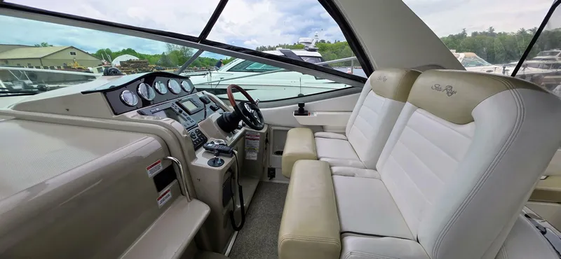  Yacht Photos Pics 2009 Sea Ray 310 Sundancer cockpit with dual seats and modern dashboard controls.