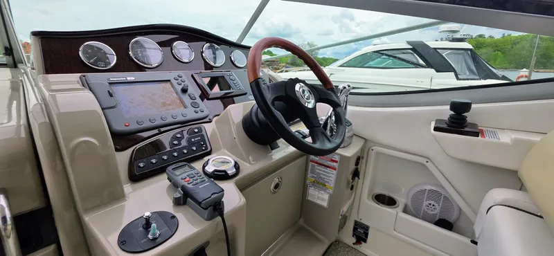  Yacht Photos Pics 2009 Sea Ray 310 Sundancer helm with gauges, controls, and steering wheel.