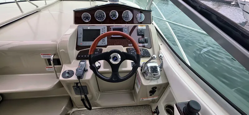  Yacht Photos Pics 2009 Sea Ray 310 Sundancer helm with gauges, steering wheel, and navigation controls.