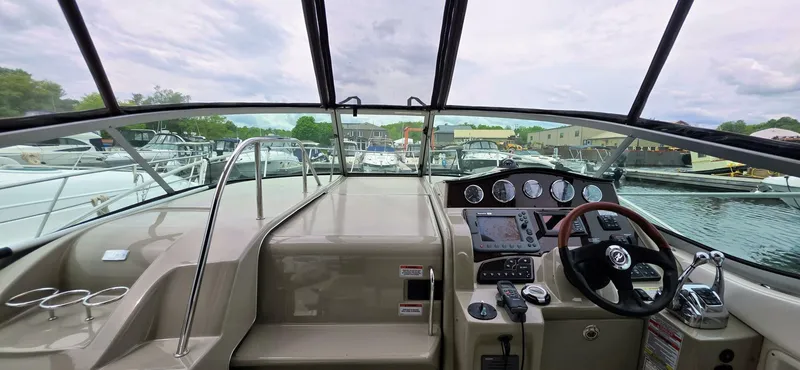  Yacht Photos Pics 2009 Sea Ray 310 Sundancer helm with navigation controls and marina view.