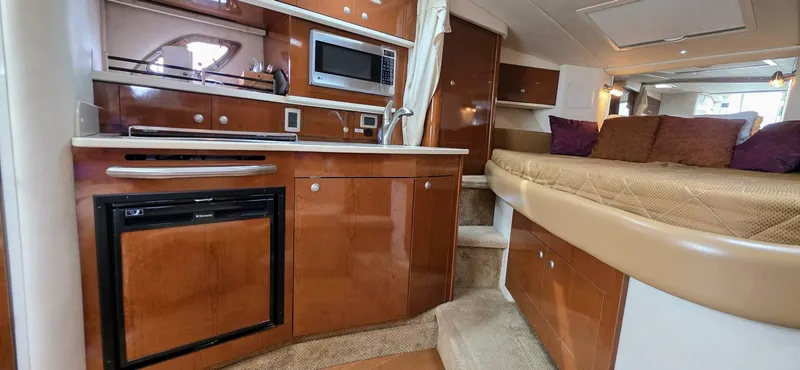  Yacht Photos Pics 2009 Sea Ray 310 Sundancer interior with kitchenette and cozy sleeping area.