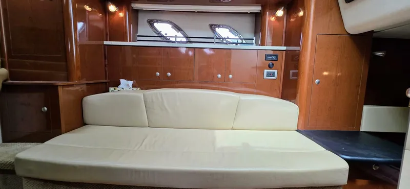  Yacht Photos Pics Luxurious interior of 2009 Sea Ray 310 Sundancer with beige leather seating and wooden cabinetry.