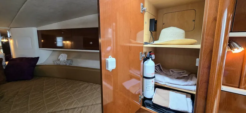  Yacht Photos Pics 2009 Sea Ray 310 Sundancer cabin with bed, storage, and fire extinguisher.