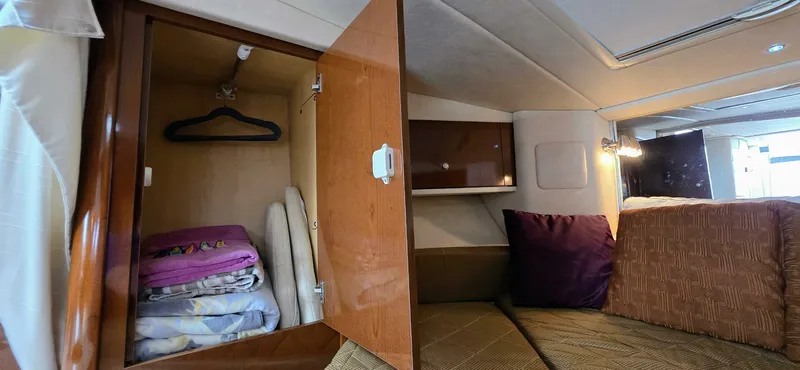  Yacht Photos Pics 2009 Sea Ray 310 Sundancer cabin with open closet, bedding, and cozy seating area.