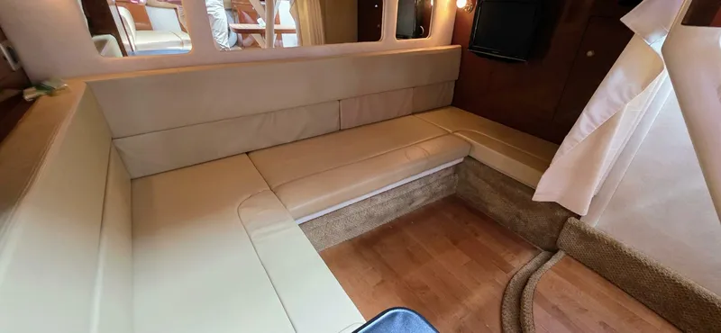  Yacht Photos Pics Interior of 2009 Sea Ray 310 Sundancer with beige seating and wooden flooring.