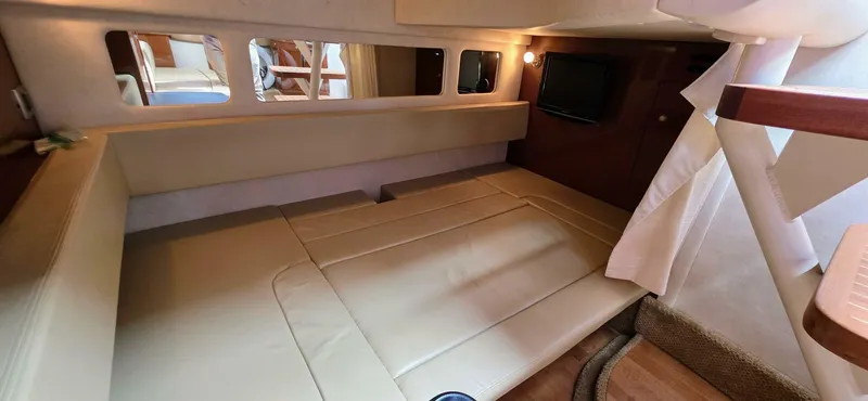  Yacht Photos Pics Interior cabin of 2009 Sea Ray 310 Sundancer, featuring beige seating and wood accents.