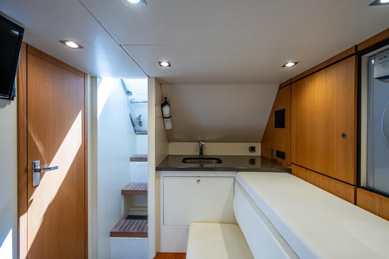 Reset Yacht Photos Pics Interior of 2015 Fairline 78 Squadron yacht with modern kitchenette and seating area.