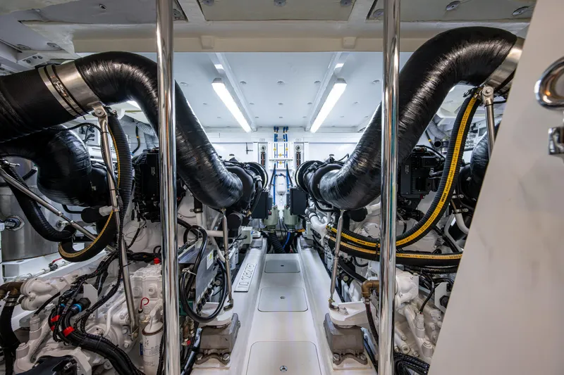 Reset Yacht Photos Pics Engine room of 2015 Fairline 78 Squadron yacht, showcasing dual engines and complex piping.