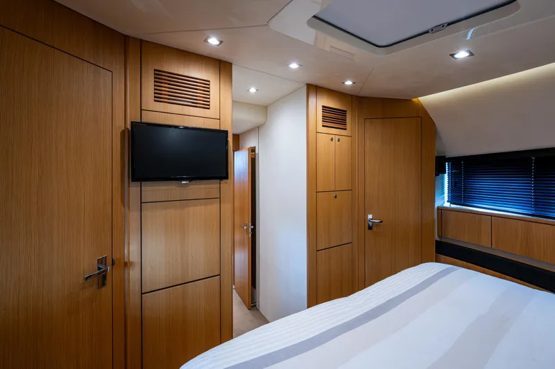 Reset Yacht Photos Pics Luxurious cabin interior of 2015 Fairline 78 Squadron yacht with wood paneling and TV.