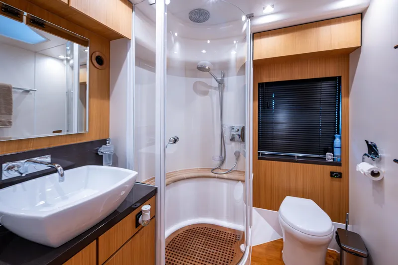 Reset Yacht Photos Pics Luxurious bathroom in 2015 Fairline 78 Squadron yacht with modern fixtures and wooden accents.