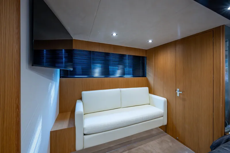Reset Yacht Photos Pics Luxurious interior of 2015 Fairline 78 Squadron yacht with modern sofa and wood paneling.
