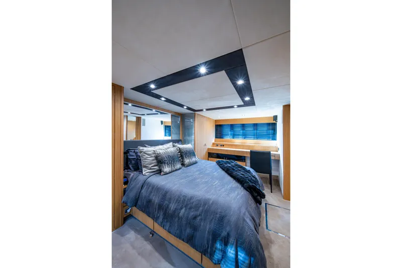 Reset Yacht Photos Pics Luxurious bedroom interior of 2015 Fairline 78 Squadron yacht with modern design and ambient lighting.