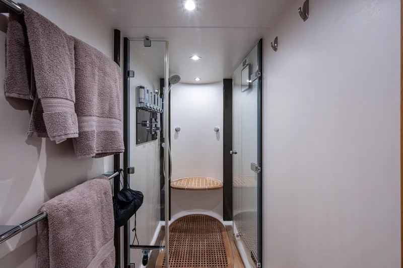 Reset Yacht Photos Pics Luxurious bathroom on 2015 Fairline 78 Squadron yacht with glass shower and plush towels.