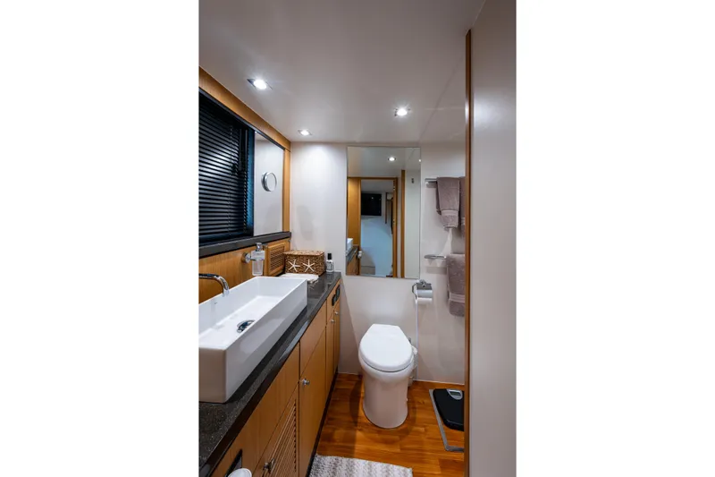 Reset Yacht Photos Pics Luxurious bathroom in 2015 Fairline 78 Squadron yacht with modern fixtures and wooden accents.