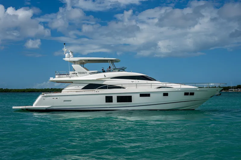 Reset Yacht Photos Pics Luxury 2015 Fairline 78 Squadron yacht cruising on turquoise waters under a blue sky.