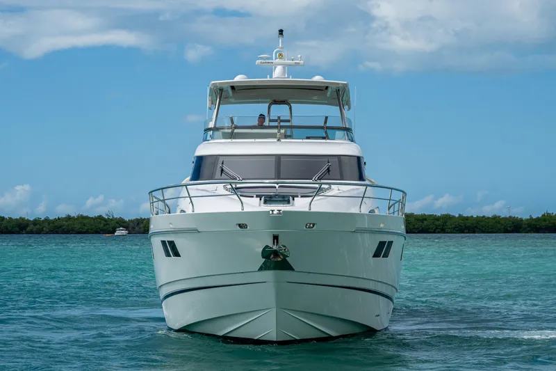 Reset Yacht Photos Pics Front view of a 2015 Fairline 78 Squadron yacht on clear blue water.