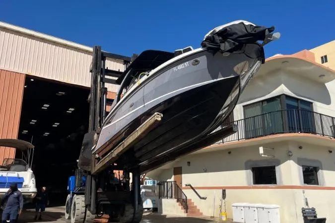Lowest Priced 280slx In Mint Condition Yacht Photos Pics 2021 Sea Ray SLX 280 boat lifted by forklift outside storage facility.