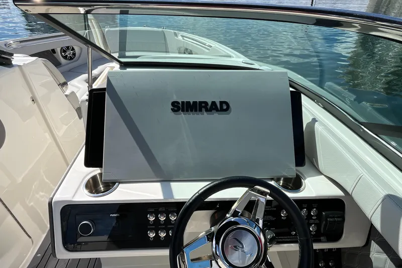 Lowest Priced 280slx In Mint Condition Yacht Photos Pics 2021 Sea Ray SLX 280 dashboard with Simrad display and steering wheel.