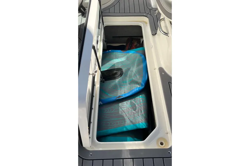 Lowest Priced 280slx In Mint Condition Yacht Photos Pics Storage compartment in 2021 Sea Ray SLX 280 boat, featuring blue gear bag.