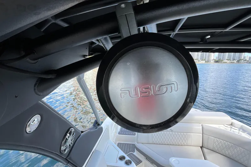 Lowest Priced 280slx In Mint Condition Yacht Photos Pics 2021 Sea Ray SLX 280 boat interior with Fusion speaker, overlooking water and cityscape.