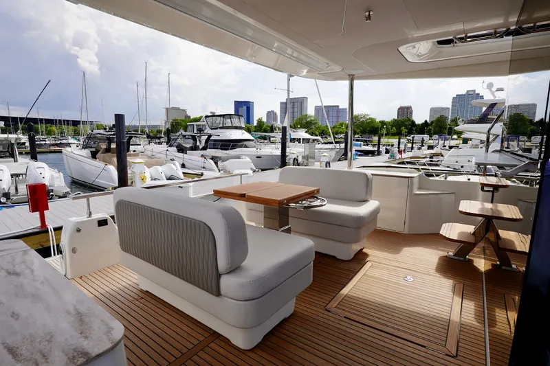  Yacht Photos Pics Luxurious Prestige F5.7 yacht interior, 2025 model, docked at a marina with city skyline view.