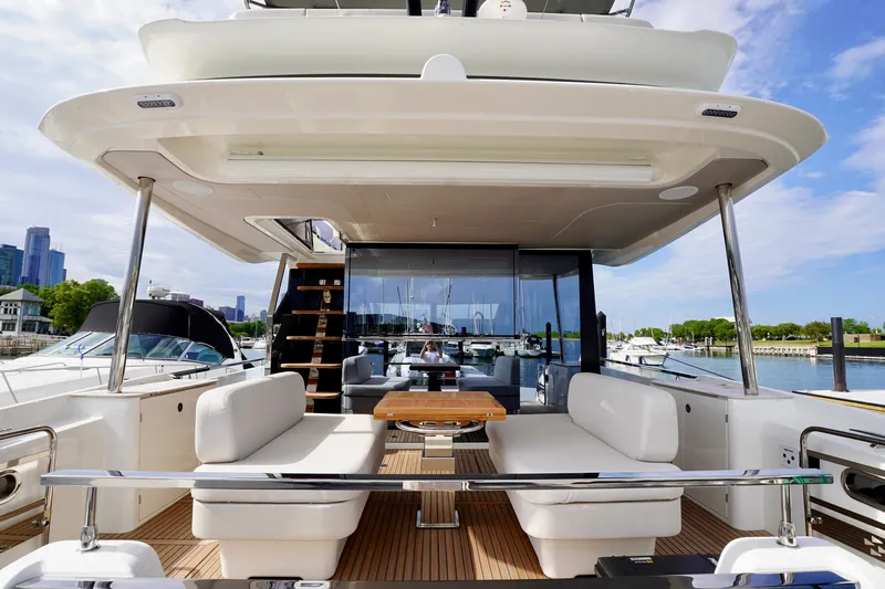  Yacht Photos Pics Luxurious 2025 Prestige F5.7 yacht with spacious deck and modern seating at marina.