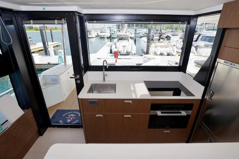  Yacht Photos Pics Modern kitchen on a 2025 Prestige F5.7 yacht with marina view.