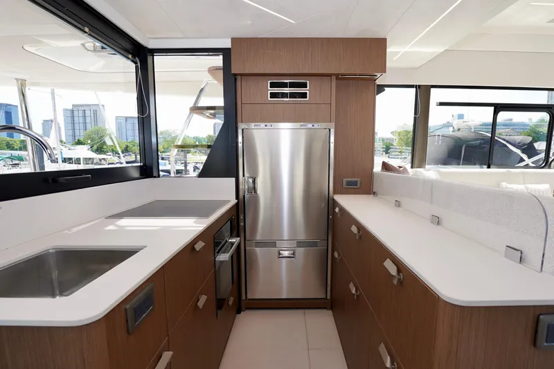  Yacht Photos Pics Modern yacht kitchen with stainless steel appliances, sleek countertops, and ample natural light. Prestige F5.7, 2025.