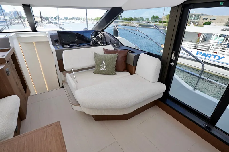  Yacht Photos Pics Luxurious interior of 2025 Prestige F5.7 yacht with plush seating and modern helm.