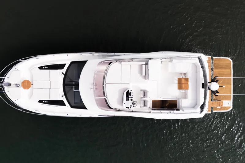  Yacht Photos Pics Overhead view of 2025 Prestige F5.7 yacht on water, showcasing sleek design and spacious deck.