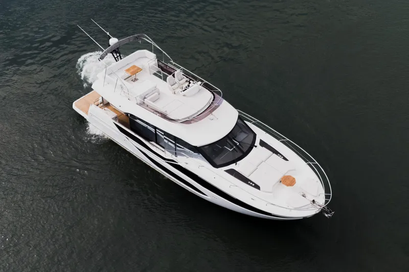  Yacht Photos Pics Aerial view of 2025 Prestige F5.7 yacht cruising on calm waters.
