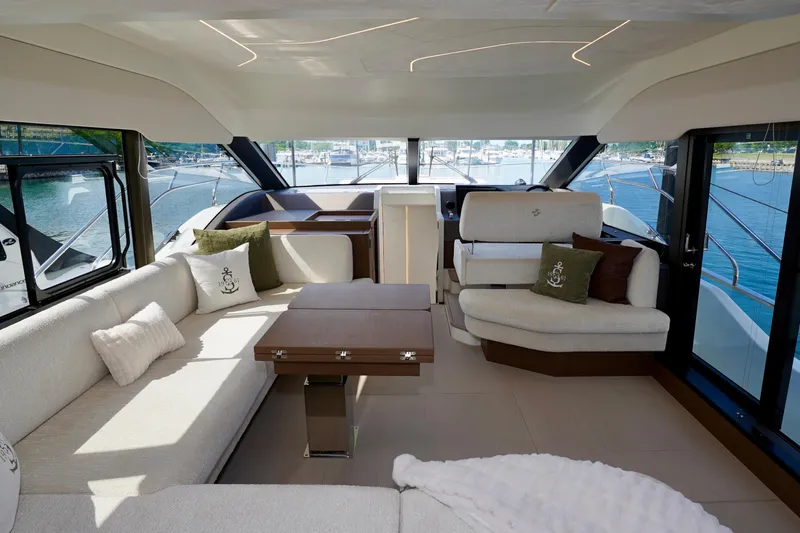  Yacht Photos Pics Luxurious interior of 2025 Prestige F5.7 yacht with elegant seating and scenic marina view.