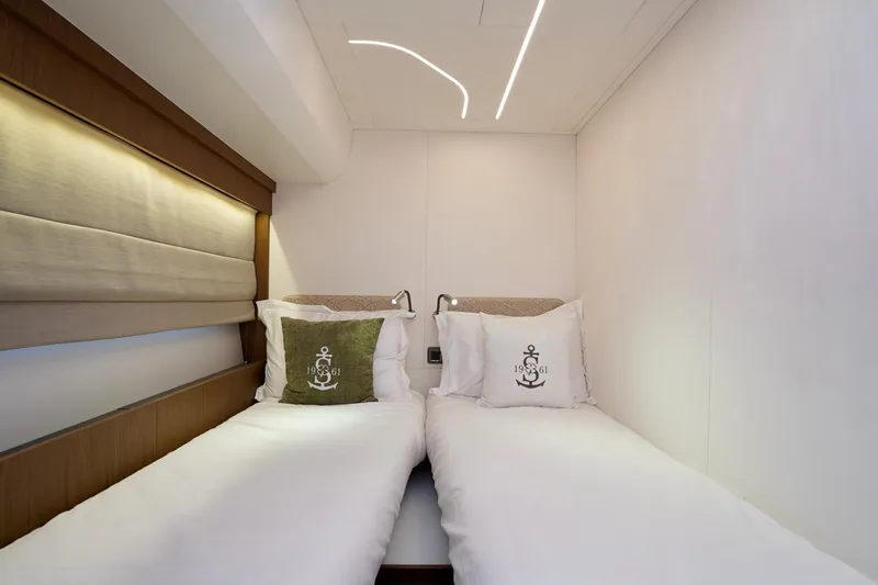  Yacht Photos Pics Luxurious twin cabin in 2025 Prestige F5.7 yacht, featuring elegant bedding and modern lighting.