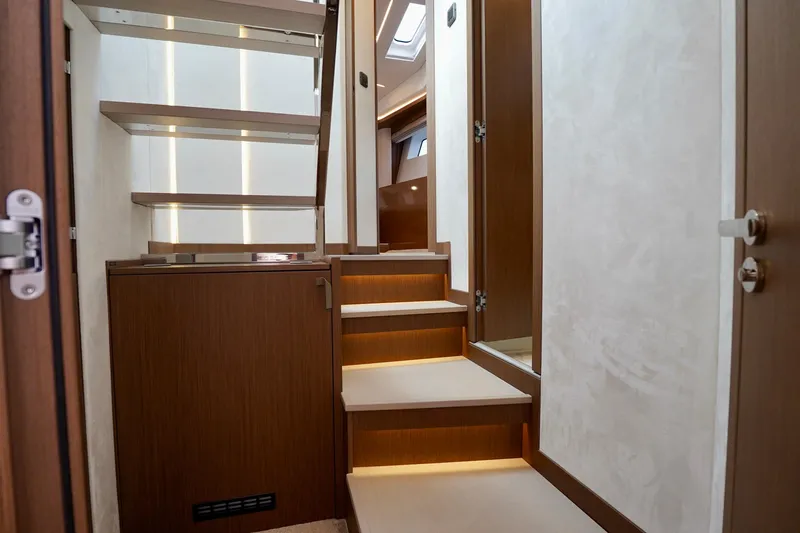  Yacht Photos Pics Modern interior staircase of 2025 Prestige F5.7 yacht with sleek wooden design.