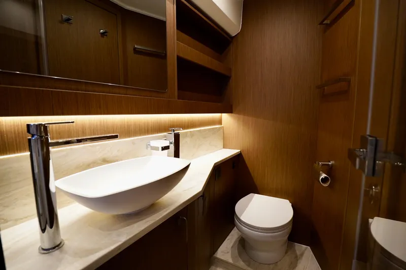  Yacht Photos Pics Luxurious bathroom in 2025 Prestige F5.7 yacht with modern fixtures and elegant wood paneling.