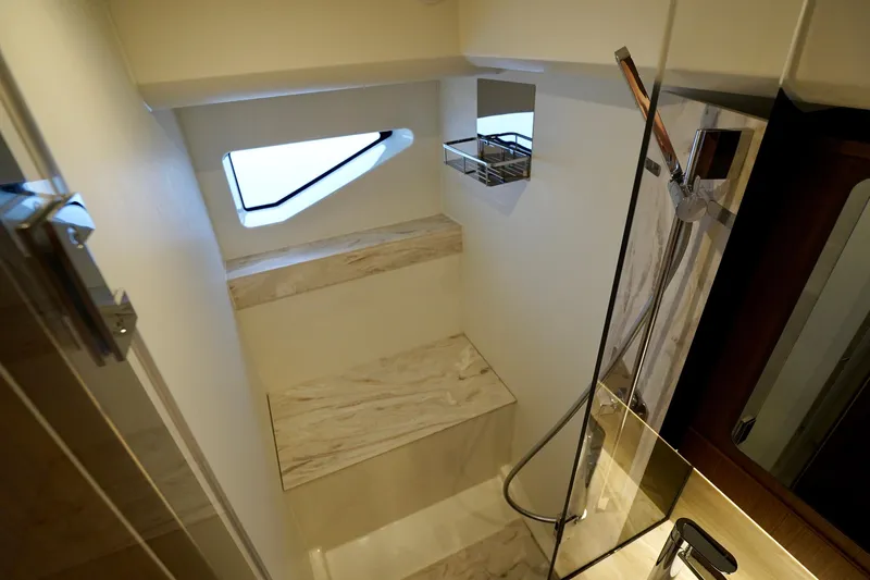  Yacht Photos Pics Luxurious bathroom in 2025 Prestige F5.7 yacht with modern shower and marble accents.