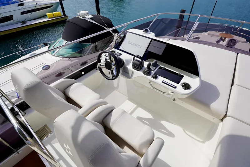  Yacht Photos Pics Luxurious 2025 Prestige F5.7 yacht cockpit with modern navigation equipment and plush seating.
